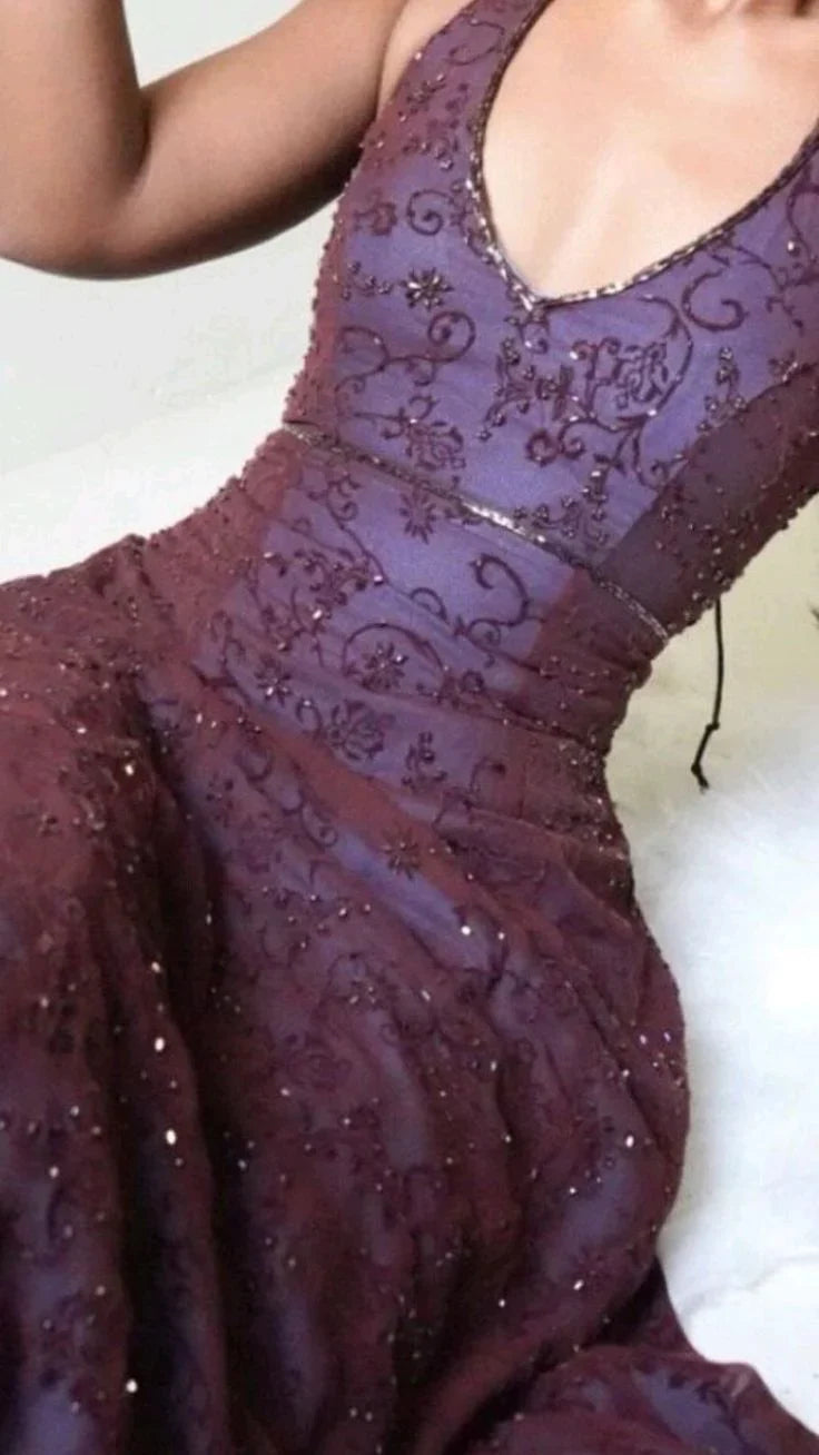 Detailed floral lace applique and texture on a deep purple formal prom dress