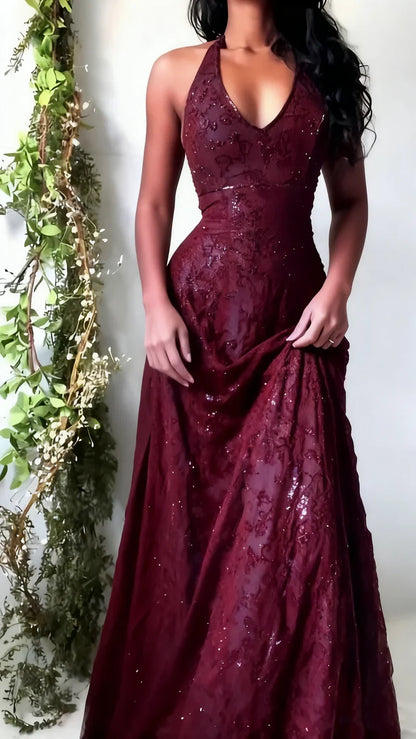 Burgundy evening gown with sequin detailing worn by a person, against a white background.